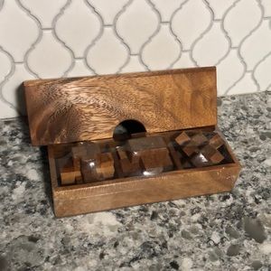 Wooden mind teaser box with three mind teasers inside